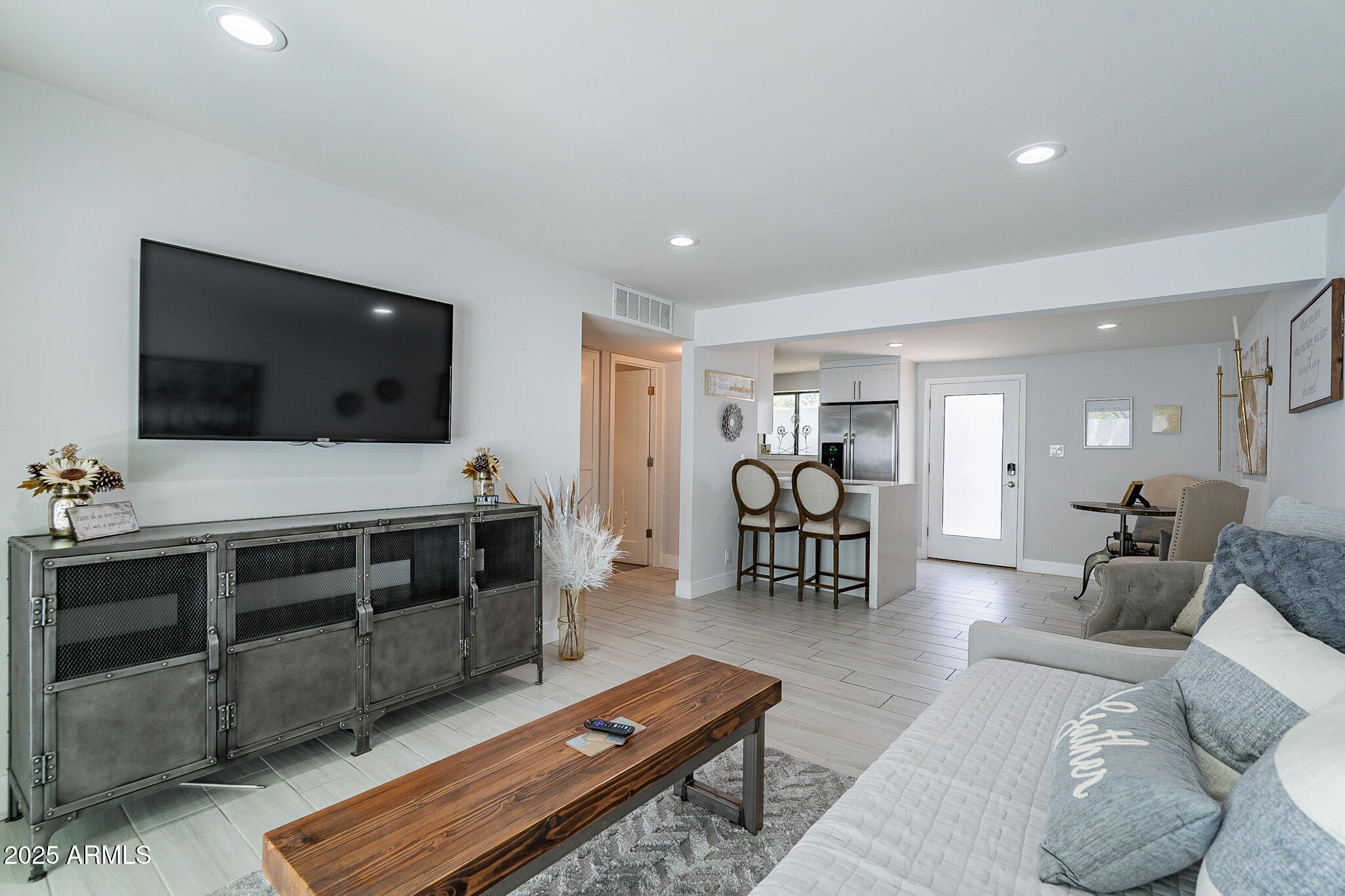 4351 North 36th Street, Unit 2 Phoenix, AZ 85018 - Photo 21 of 24 a living room with furniture and a flat screen tv