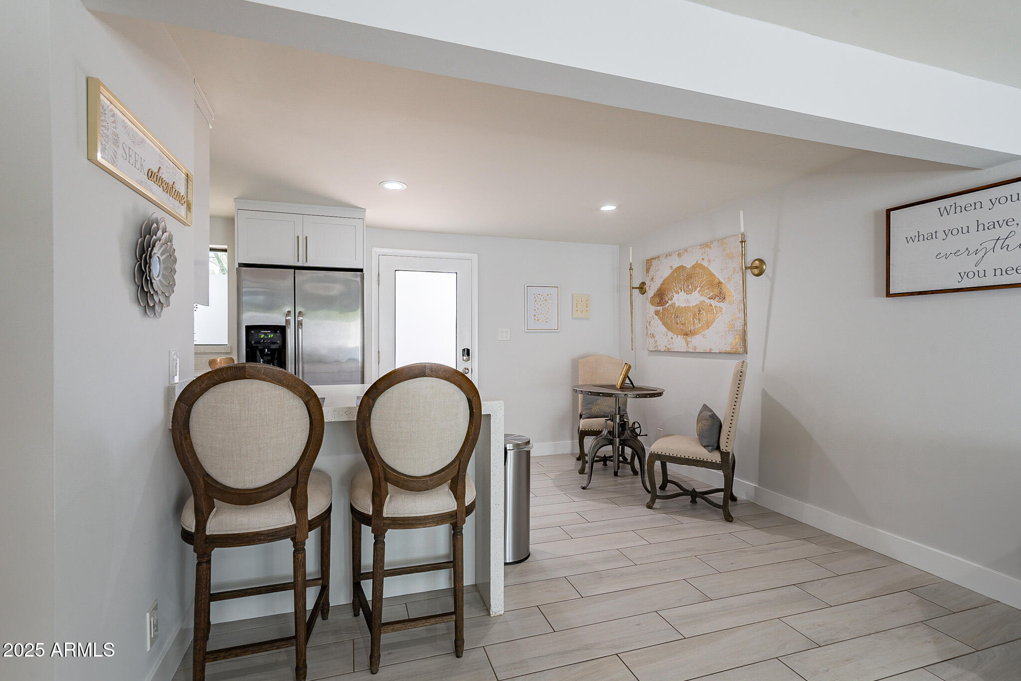 4351 North 36th Street, Unit 2 Phoenix, AZ 85018 - Photo 3 of 24 a very nice looking dining room with kitchen island furniture a sink and a mirror