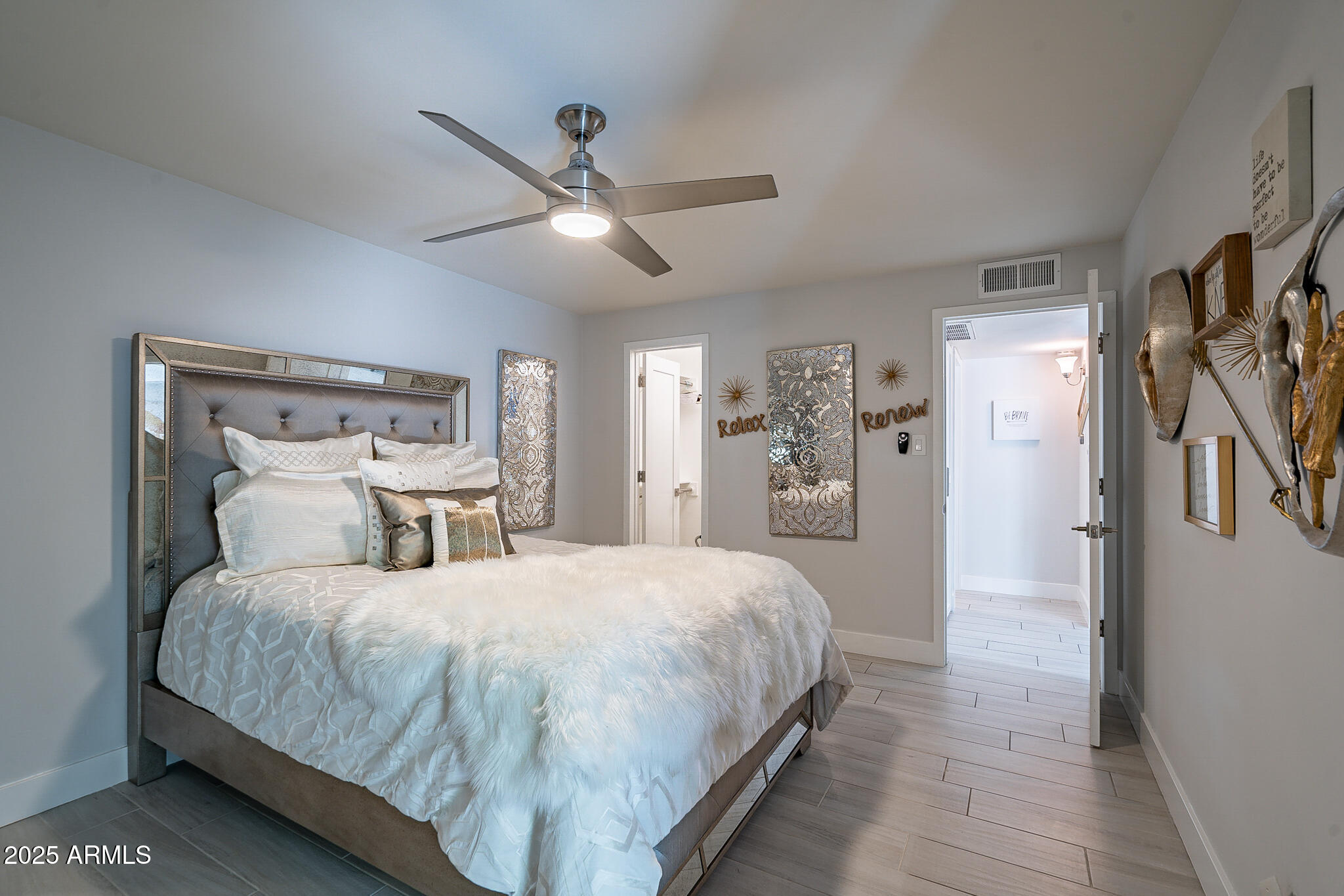 4351 North 36th Street, Unit 2 Phoenix, AZ 85018 - Photo 6 of 24 a bedroom with a large bed and a chandelier