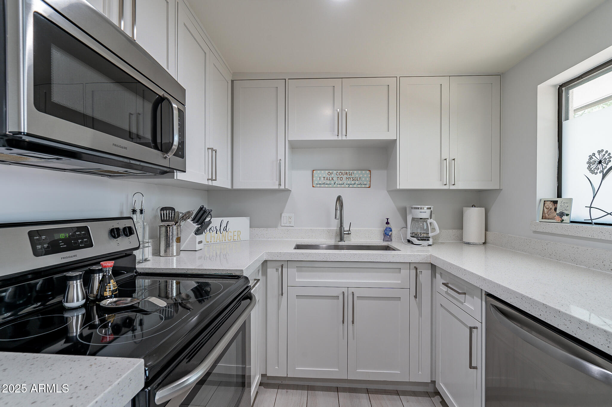 4351 North 36th Street, Unit 2 Phoenix, AZ 85018 - Photo 9 of 24 a kitchen with stainless steel appliances granite countertop a sink stove oven and white cabinets