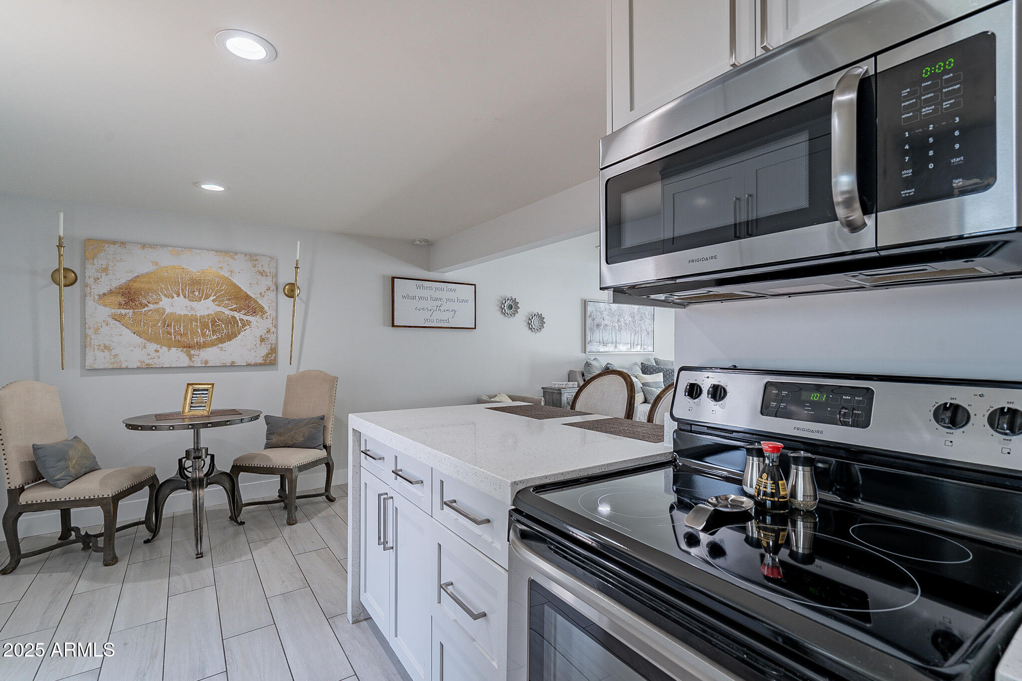 4351 North 36th Street, Unit 2 Phoenix, AZ 85018 - Photo 10 of 24 a kitchen with a stove and a microwave