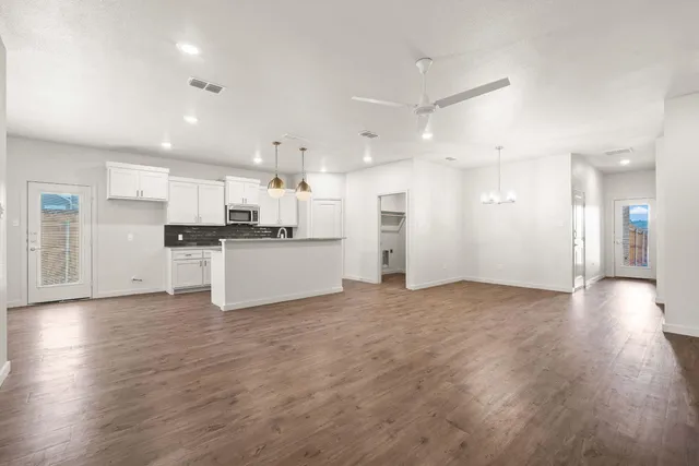 a view of kitchen with wooden floor and electronic appliances