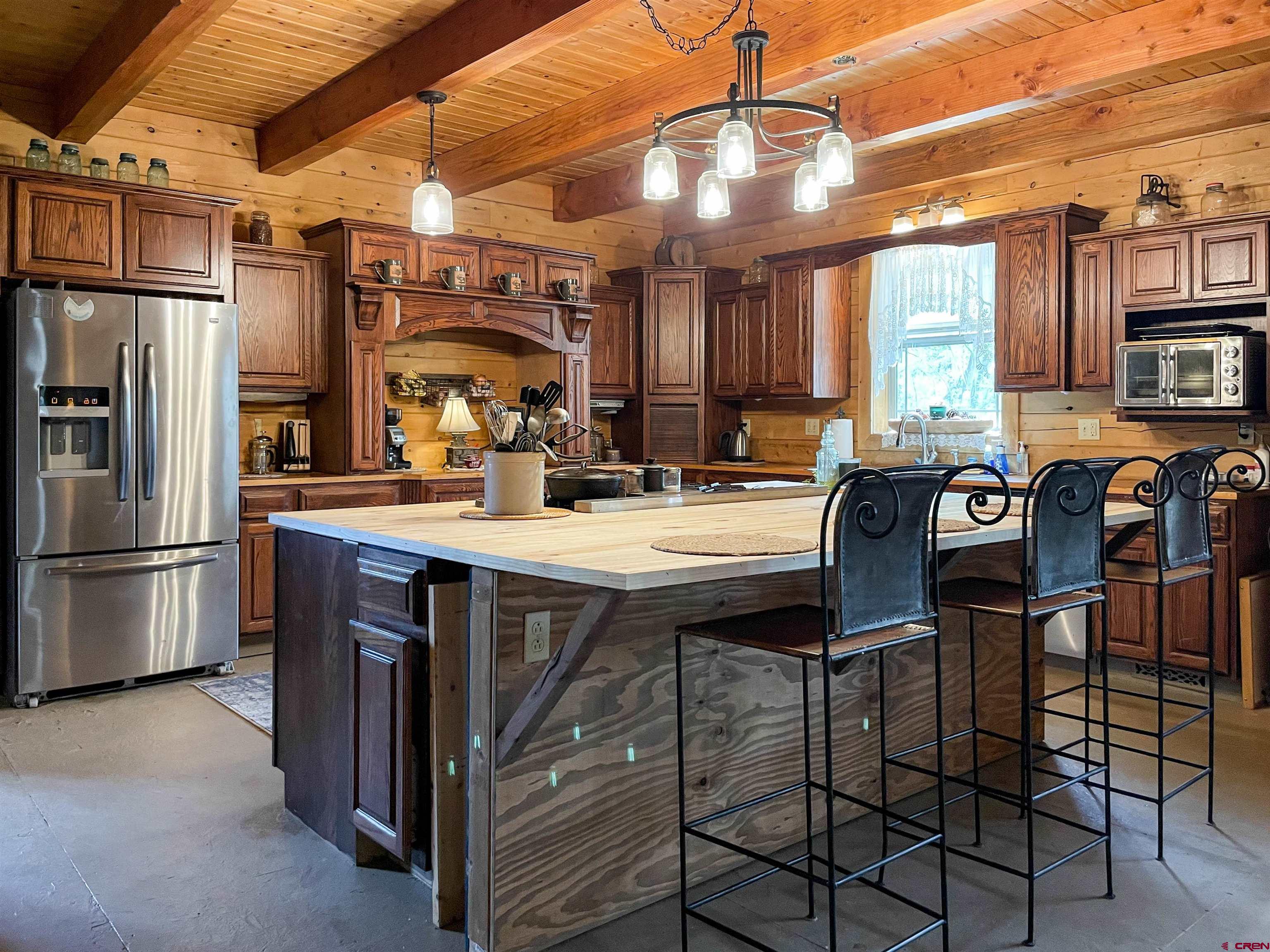 10427 2150th Road Austin, CO 81410 - Photo 14 of 35 a kitchen with stainless steel appliances a table chairs and a refrigerator