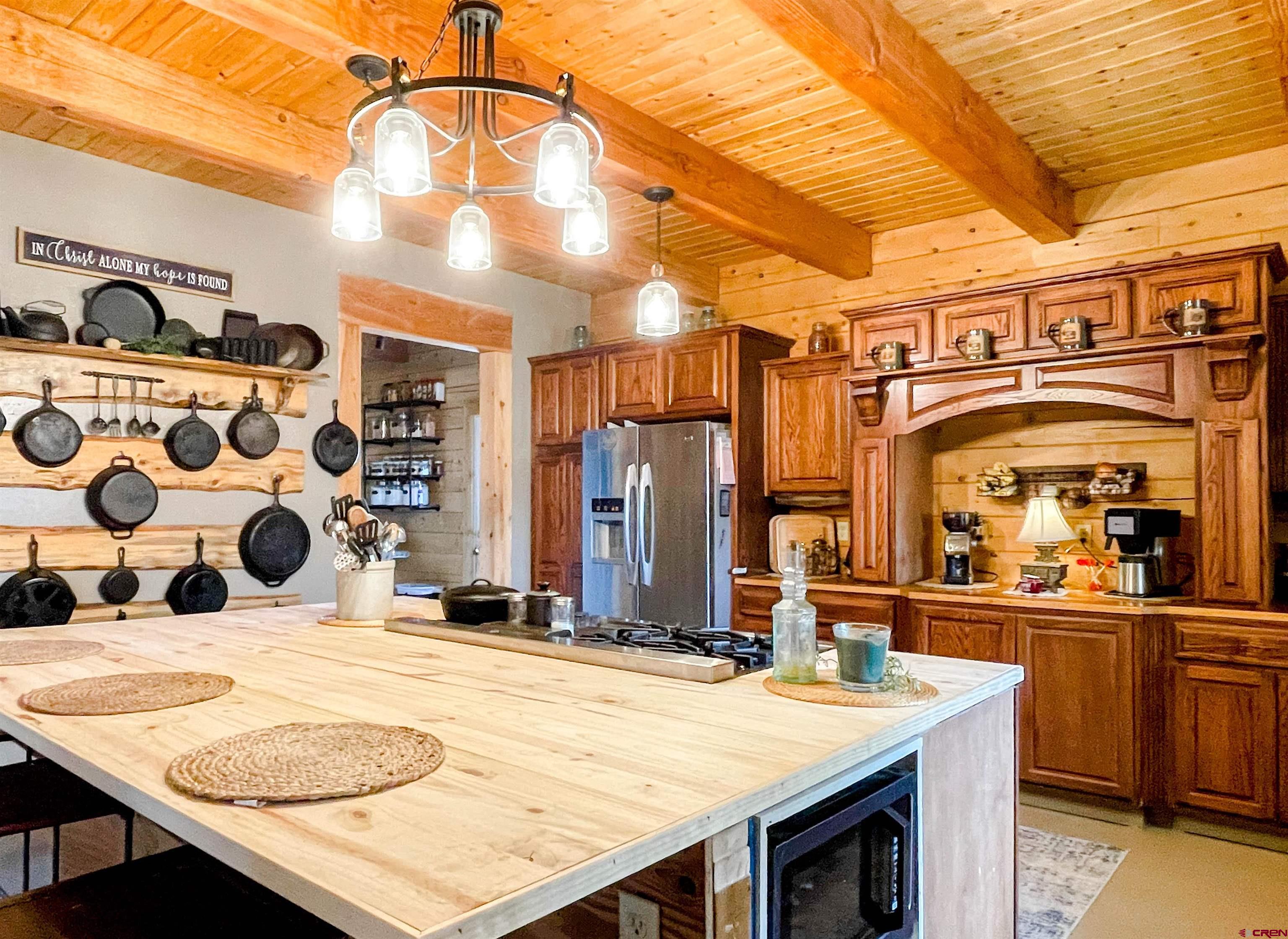 10427 2150th Road Austin, CO 81410 - Photo 15 of 35 a dining table with a stove and kitchen view