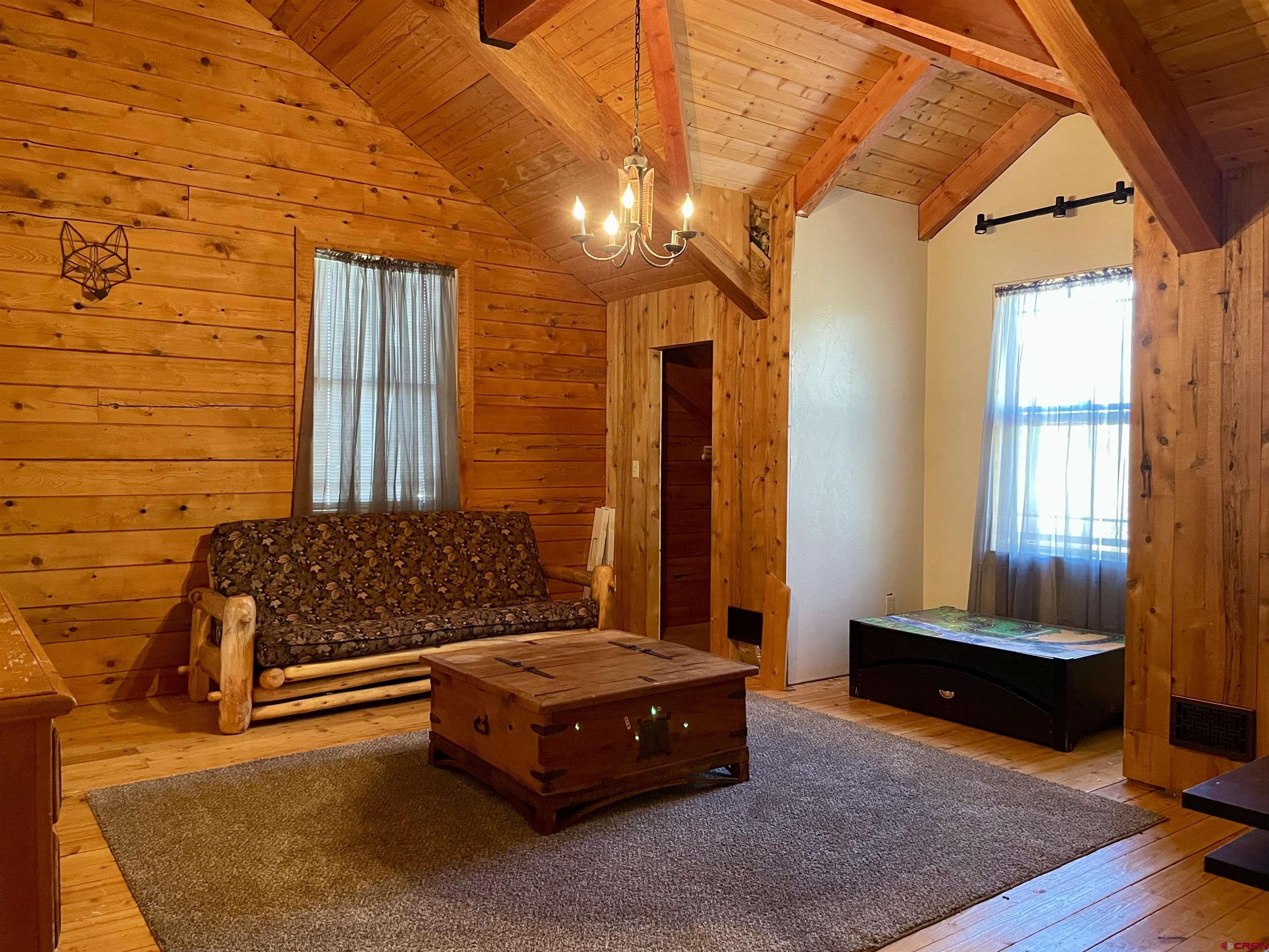 10427 2150th Road Austin, CO 81410 - Photo 26 of 35 a bedroom with a bed and wooden floor