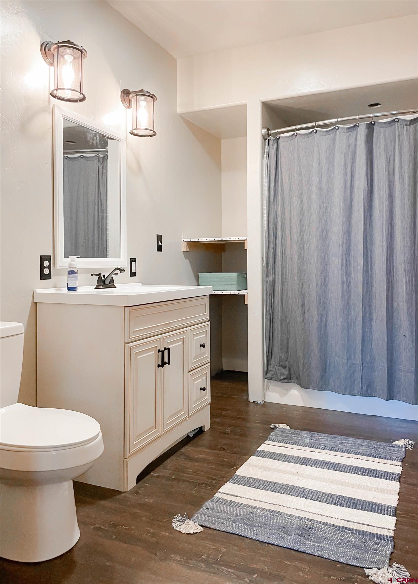 10427 2150th Road Austin, CO 81410 - Photo 31 of 35 a bathroom with a sink toilet and shower