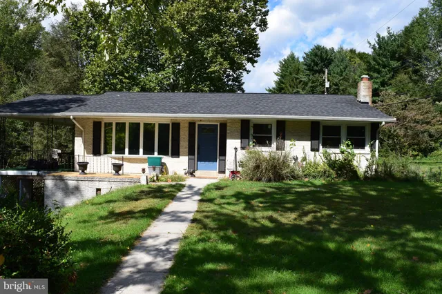 a front view of a house with a yard table and chairs