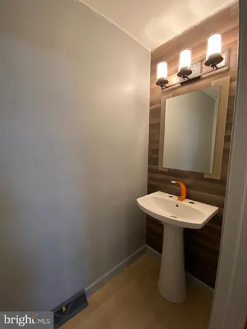 a bathroom with a sink a mirror and vanity
