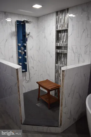 a white bath tub sitting in a bathroom