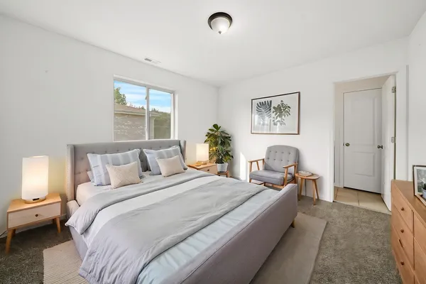 a bed room with a bed and a window