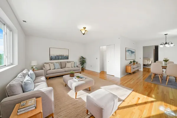 a living room with furniture and wooden floor
