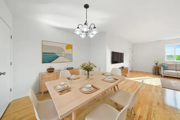 a view of a dining room with furniture and wooden floor