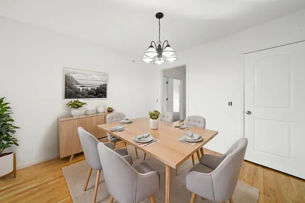 a view of a dining room with furniture wooden floor and a chandelier