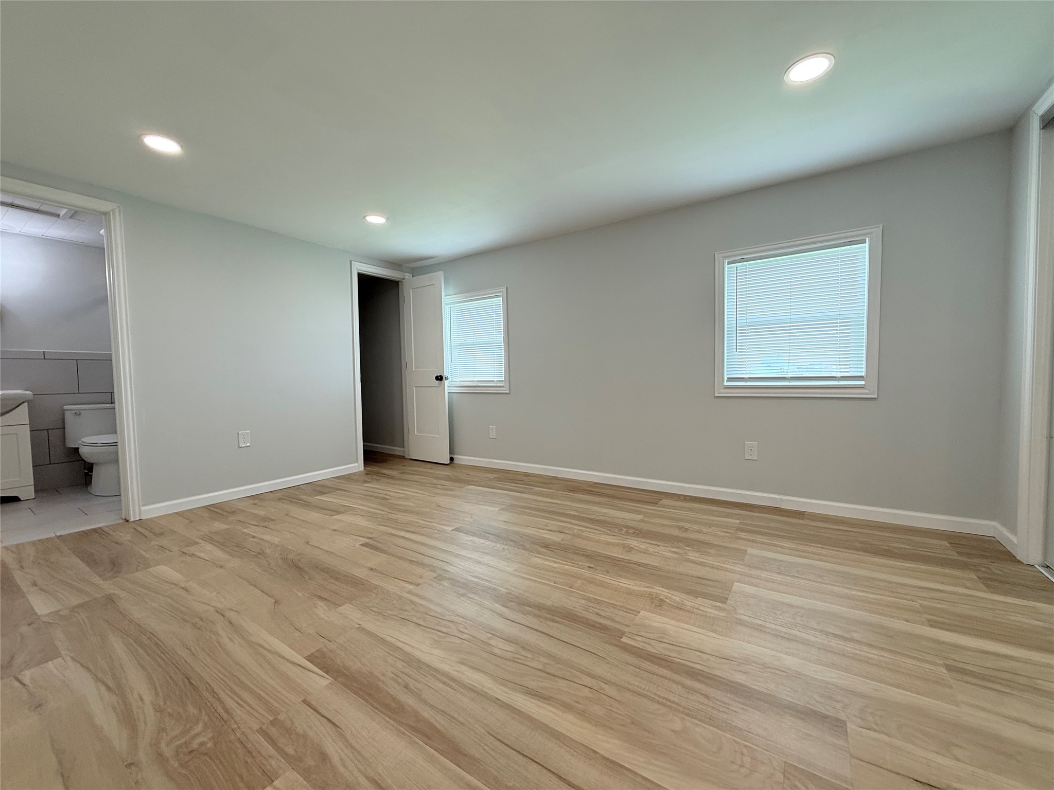 2154 County Road 230 Sargent, TX 77414 - Photo 22 of 30 an empty room with wooden floor and windows