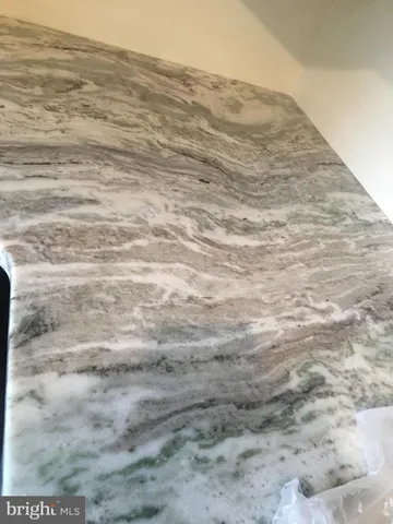 a view of a dry yard in front of the wall