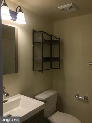 a bathroom with a sink toilet and vanity