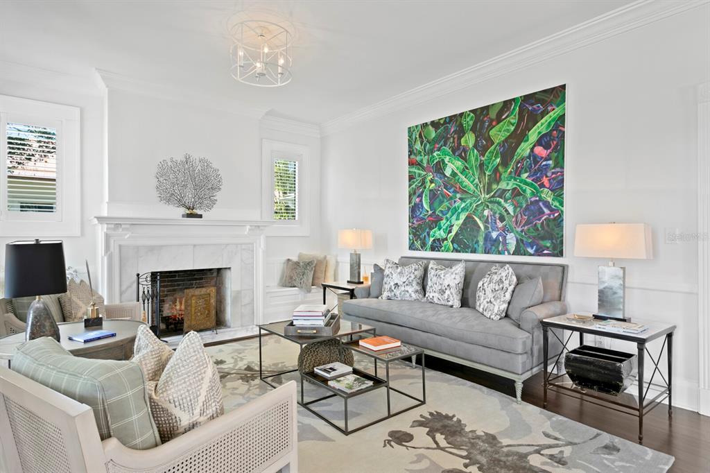 147 Edgewater Drive Dunedin, FL 34698 - Photo 11 of 99 a living room with furniture a fireplace and a window