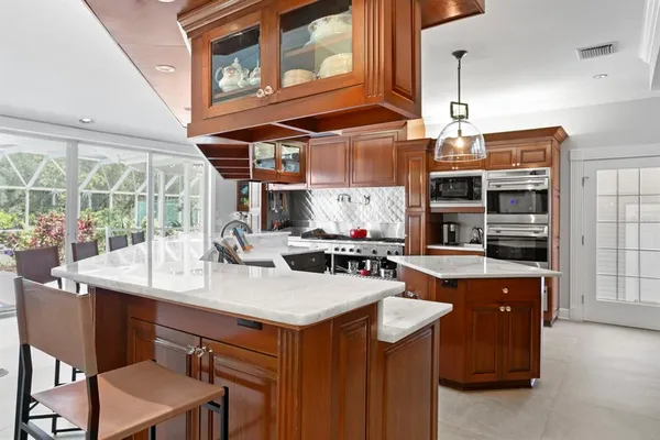 a living room with furniture and a view of kitchen