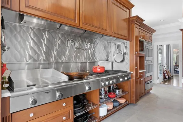 a kitchen with stainless steel appliances granite countertop a refrigerator and a stove