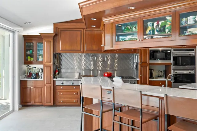 a kitchen with stainless steel appliances granite countertop a refrigerator and a stove