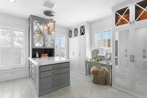 a bedroom with a large bed and a chandelier