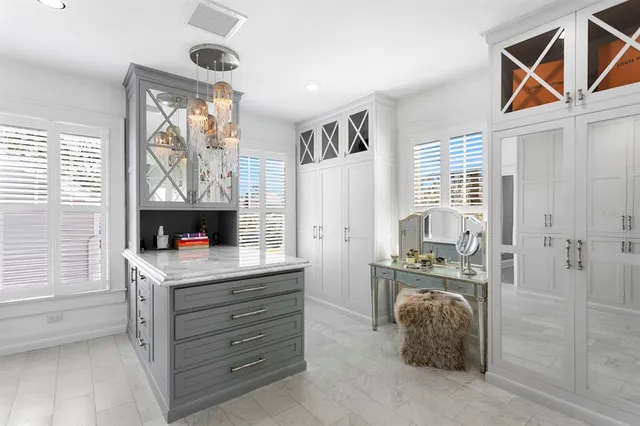 a bedroom with a large bed and a chandelier