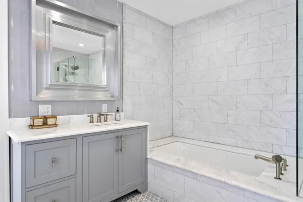 a bathroom with a sink a toilet and a mirror