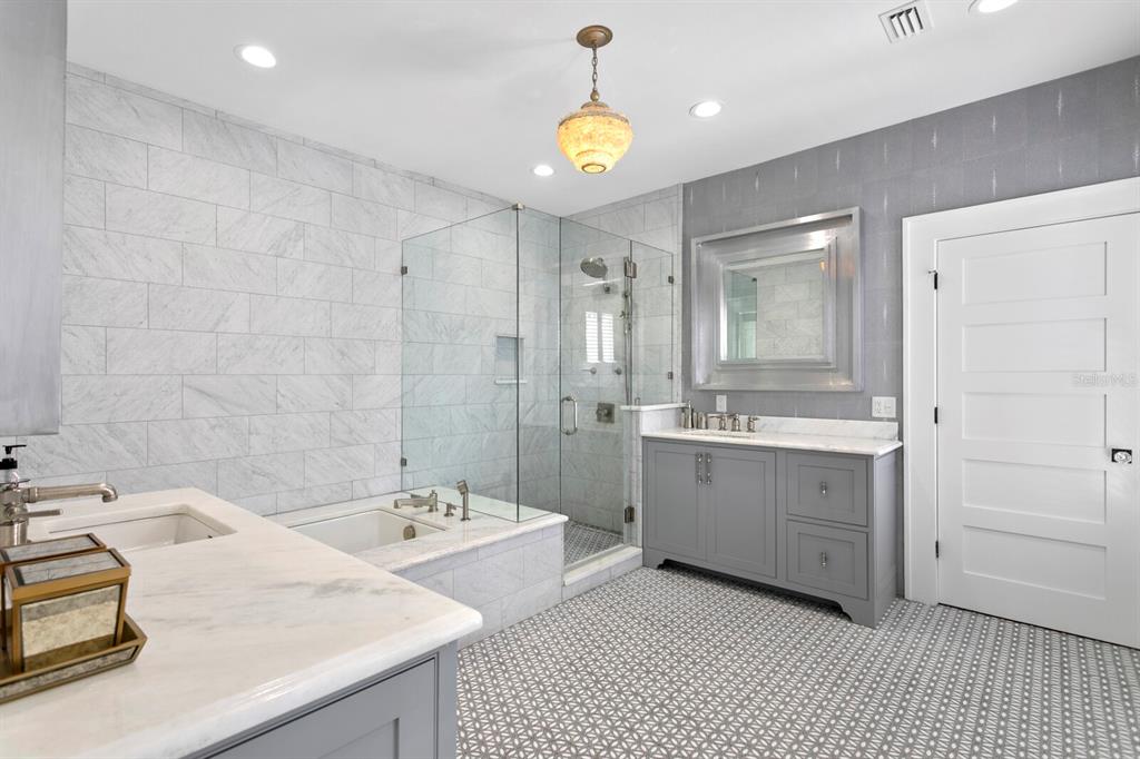 147 Edgewater Drive Dunedin, FL 34698 - Photo 35 of 99 a bathroom with a sink double vanity and a shower