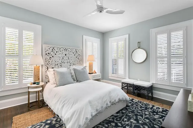 a view of a dining room with furniture large windows and wooden floor