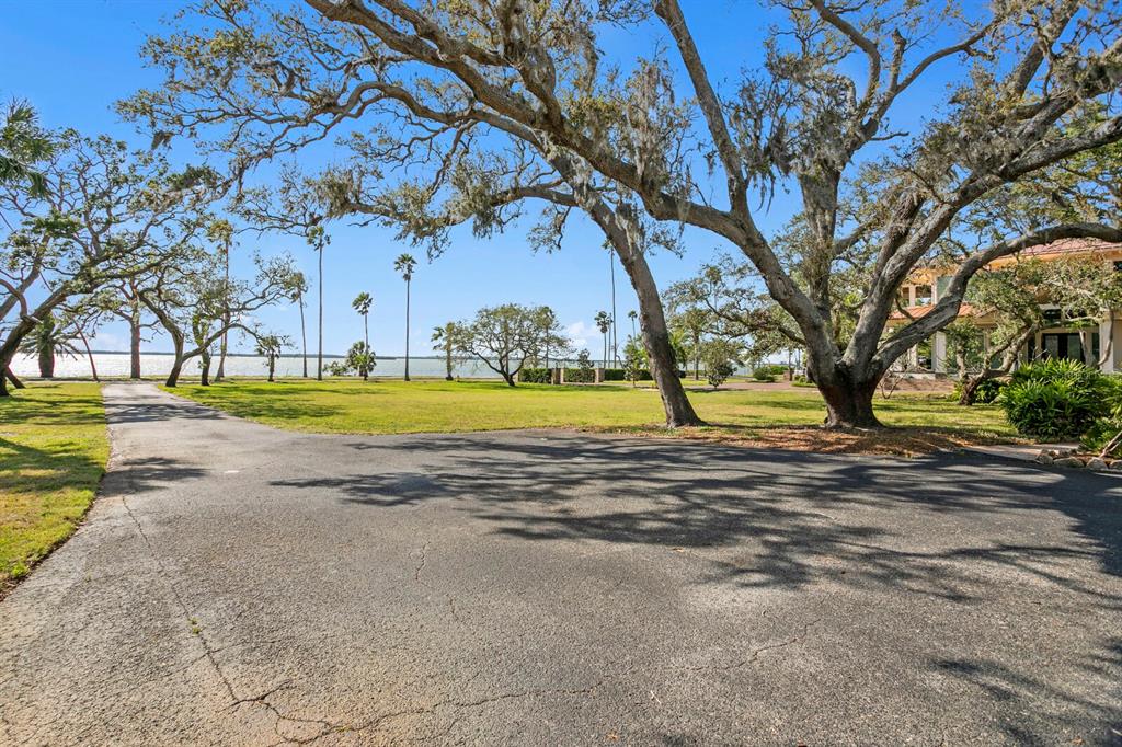 147 Edgewater Drive Dunedin, FL 34698 - Photo 41 of 99 a view of a swimming pool with an outdoor space and seating area