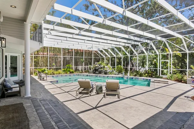 a view of a tennis ground with large trees