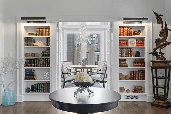 a living room with furniture and view of kitchen