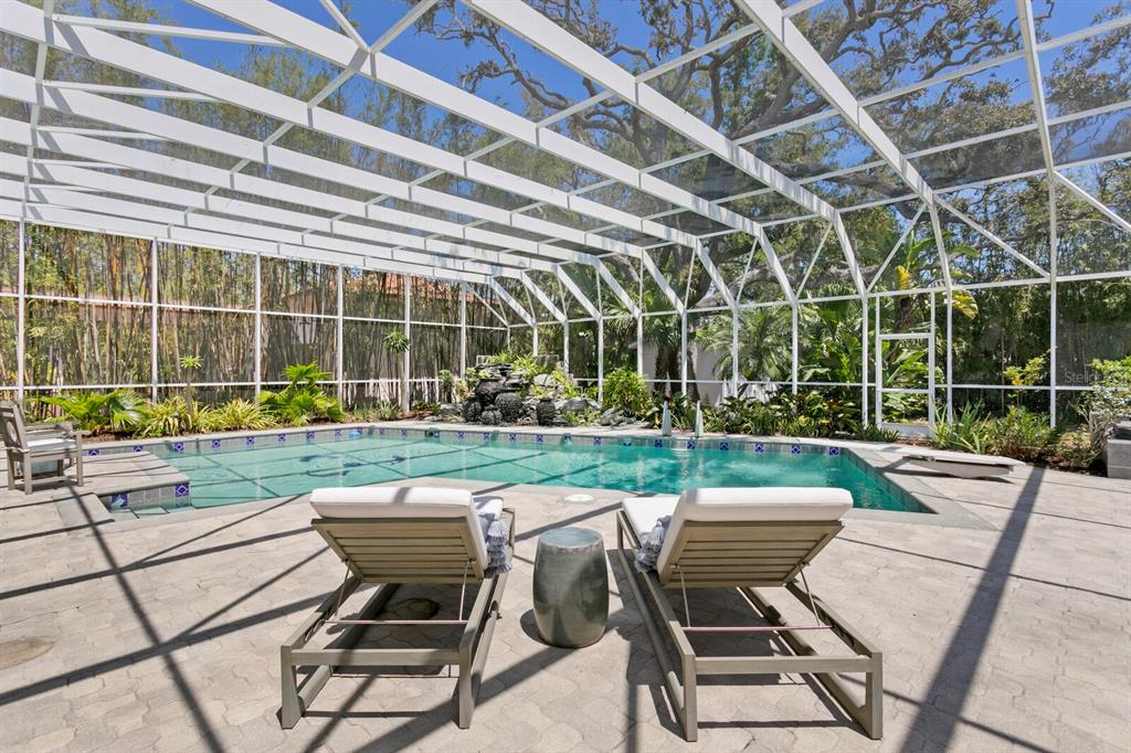 147 Edgewater Drive Dunedin, FL 34698 - Photo 51 of 99 a view of a chairs and table in the patio