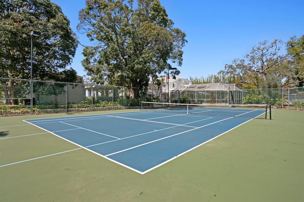 147 Edgewater Drive Dunedin, FL 34698 - Photo 52 of 99 a view of a tennis court with trees