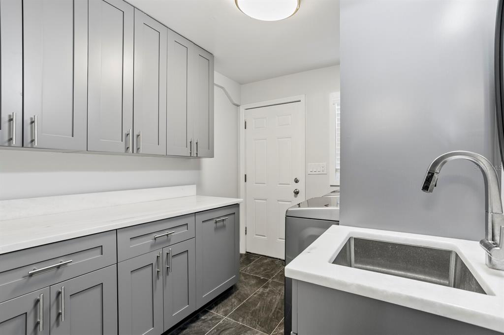 147 Edgewater Drive Dunedin, FL 34698 - Photo 69 of 99 a kitchen with a sink and cabinets