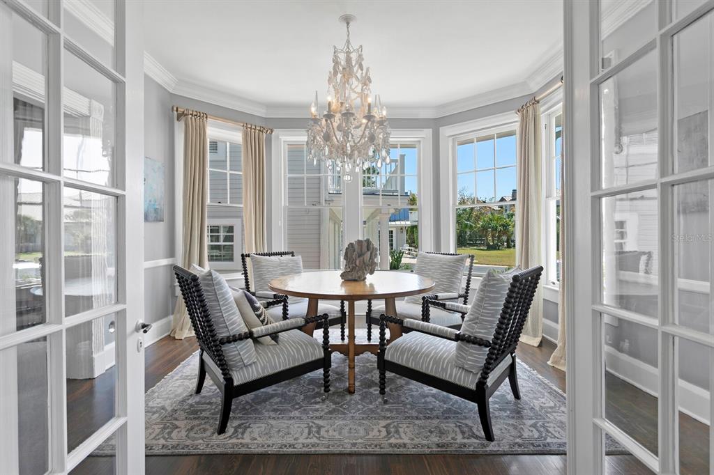 147 Edgewater Drive Dunedin, FL 34698 - Photo 7 of 99 a dining room with furniture a chandelier and wooden floor