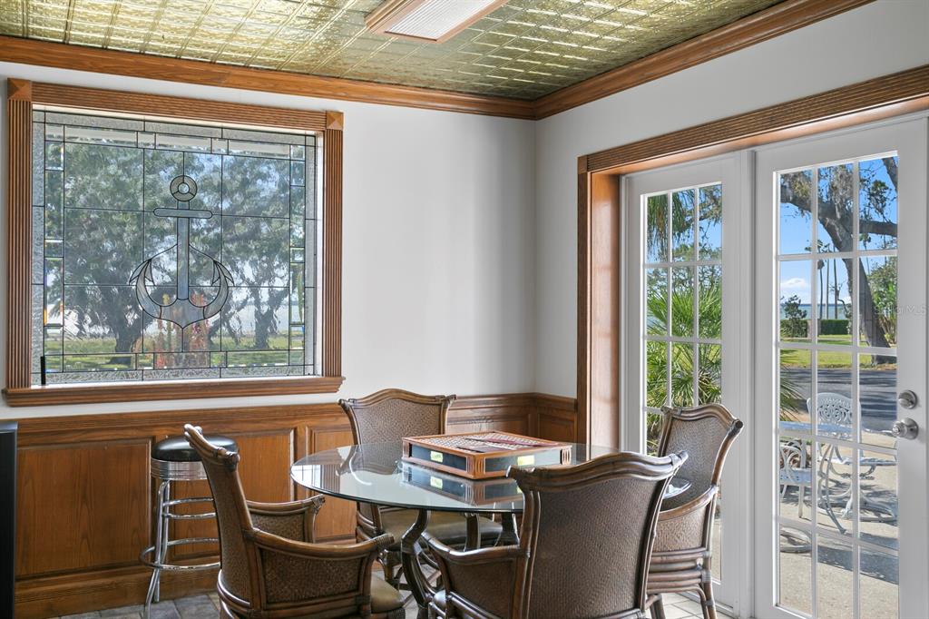 147 Edgewater Drive Dunedin, FL 34698 - Photo 74 of 99 a view of a dining room with furniture large windows and wooden floor