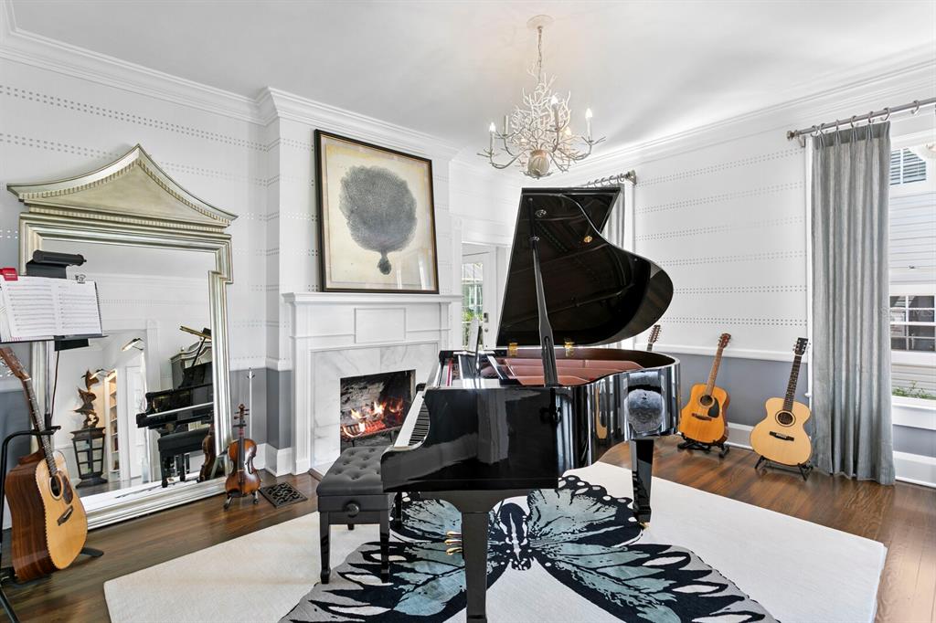 147 Edgewater Drive Dunedin, FL 34698 - Photo 8 of 99 a living room with furniture a fireplace and a chandelier