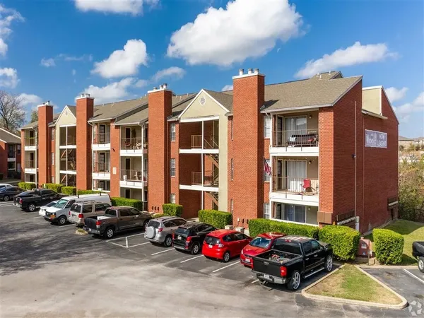 a cars parked in front of a brick building