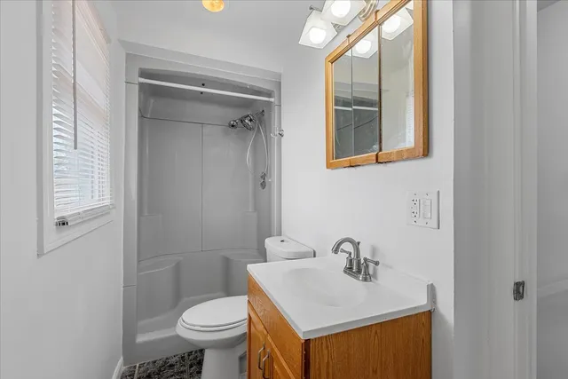 a bathroom with a sink toilet and a mirror