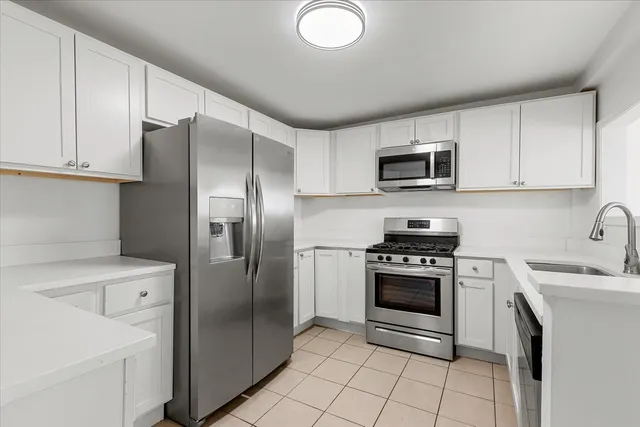 a kitchen with a stove sink and refrigerator