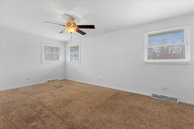 a view of a living room with a ceiling fan