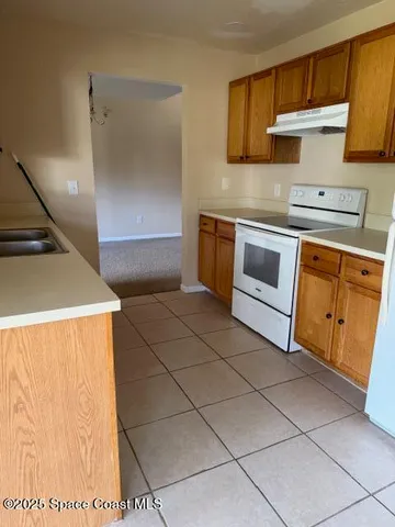 a kitchen with stainless steel appliances a stove a sink and a refrigerator
