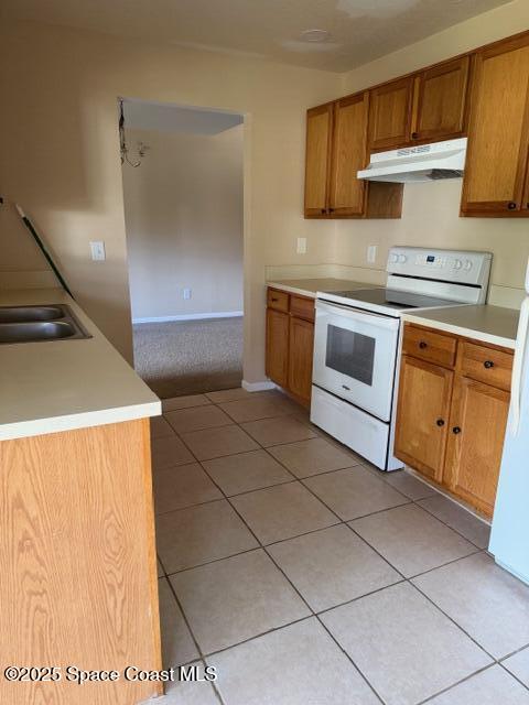 879 Remsen Avenue Northwest Palm Bay, FL 32907 - Photo 5 of 12 a kitchen with stainless steel appliances a stove a sink and a refrigerator