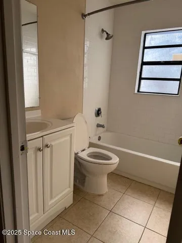 a bathroom with a toilet a sink and bathtub