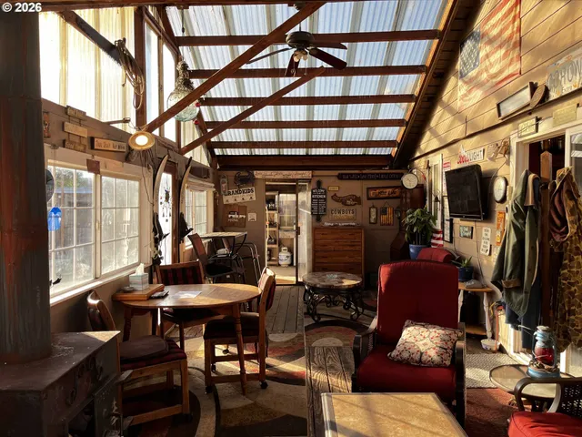 a view of a livingroom with furniture and a window