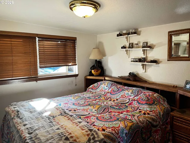 a bedroom with a bed and window