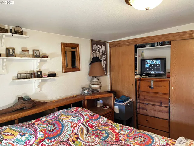 a bedroom with a bed and a dresser in it