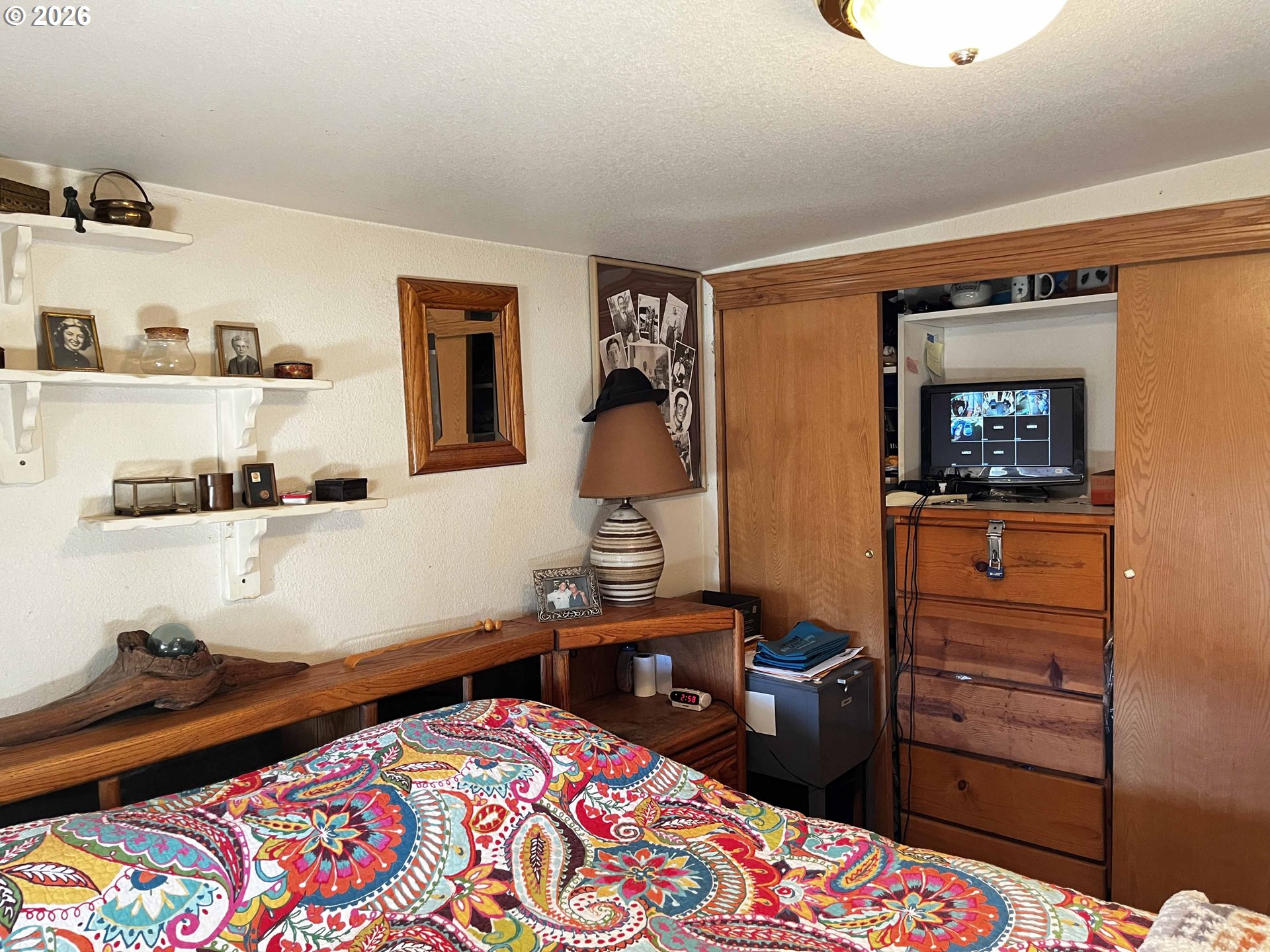 1890 37th Street Florence, OR 97439 - Photo 8 of 41 a bedroom with a bed and a dresser in it