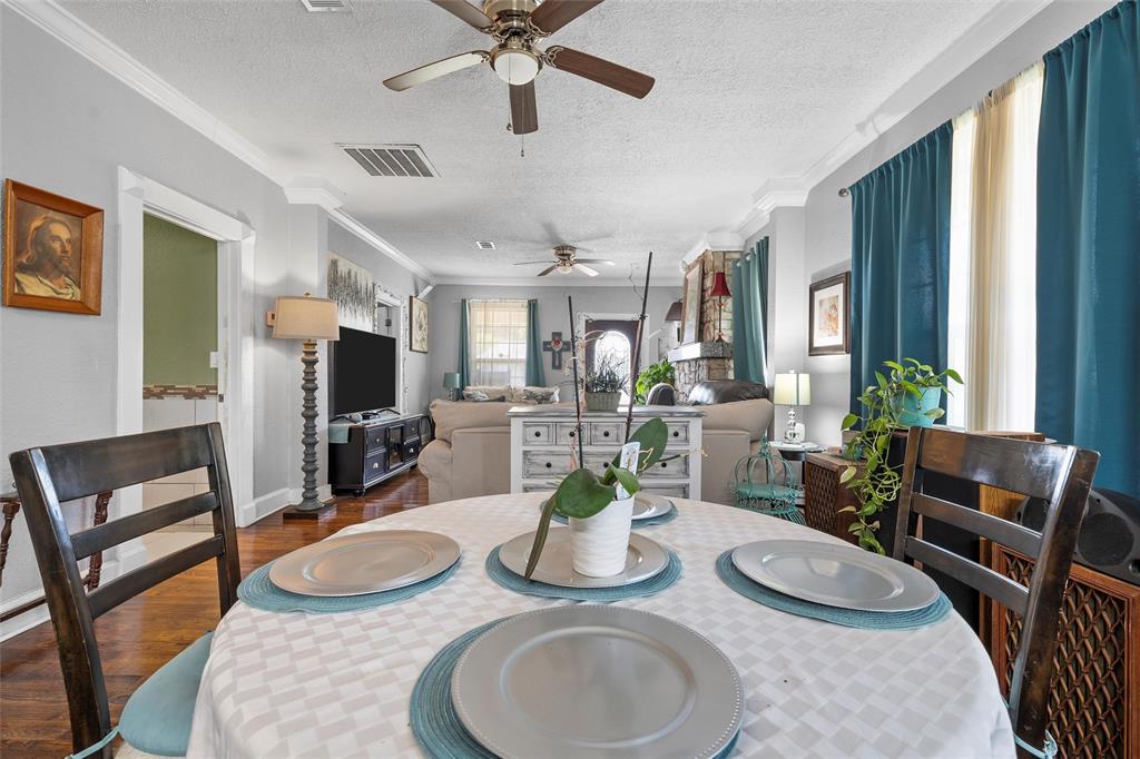 2700 Cole Avenue Waco, TX 76707 - Photo 6 of 14 Dining room with ceiling fan, wood finished floors, a textured ceiling, and crown molding